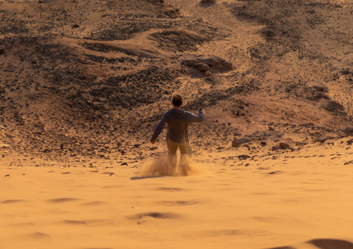 Tourist going down the sand dune of jebel Barkal, Northern State, Karima, Sudan