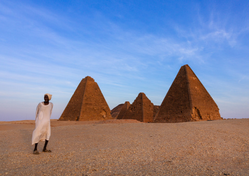 Old sudanese man in front of the meroitic pyramids of jebel Barkal, Northern State, Karima, Sudan