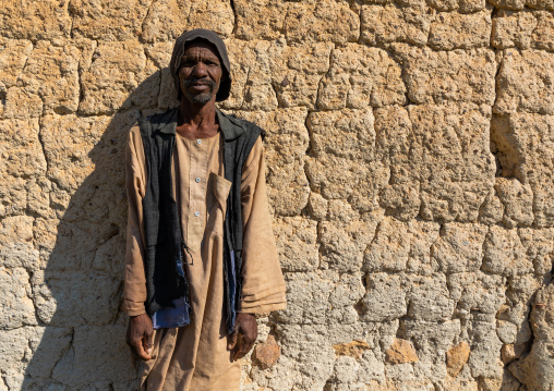 Bisharin nomad man collecting salt in Atrun crater, Bayuda desert, Atrun, Sudan