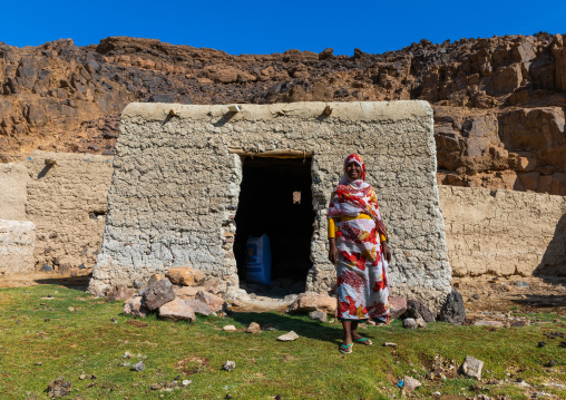 Bisharin nomad woman collecting salt in Atrun crater, Bayuda desert, Atrun, Sudan