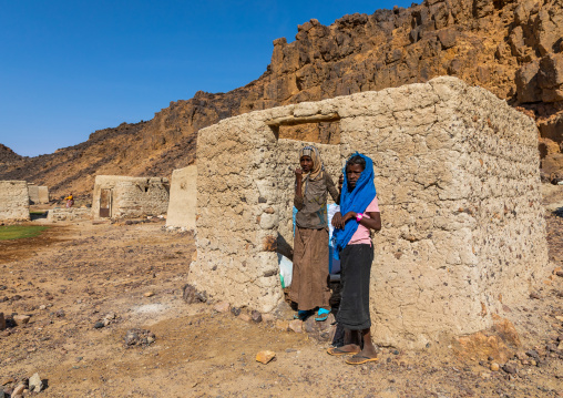 Bisharin nomad girls collecting salt in Atrun crater, Bayuda desert, Atrun, Sudan