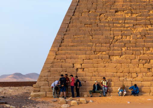 Tourists at the bottom of the pyramids of the kushite rulers at Meroe, Northern State, Meroe, Sudan