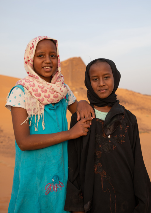 Portrait of sudanese girls visiting the pyramids of the kushite rulers at Meroe, Northern State, Meroe, Sudan