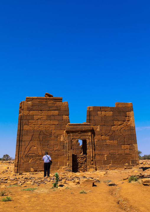Tourist taking pictures of the lion temple of Apedemak, Nubia, Naqa, Sudan