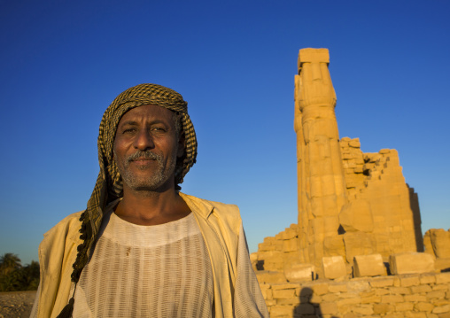 Sudan, Nubia, Soleb, sudanese man in front of the big soleb temple built by amenophis iii