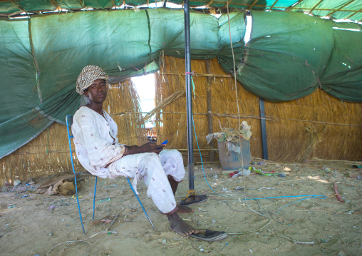 Sudan, Khartoum State, Alkhanag, man sitting under a tent