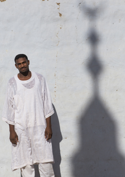 Sudan, Nubia, Tumbus, nubian man standing in front of a wall with a minaret shadow