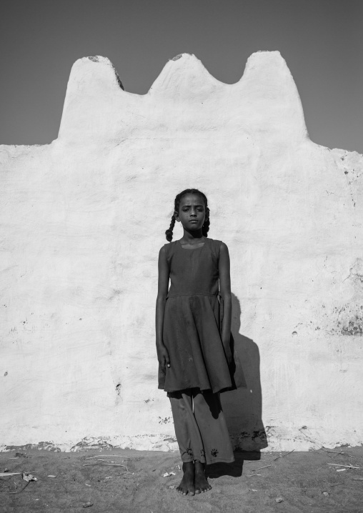 Sudan, Nubia, Tumbus, girl standing in front of a wall