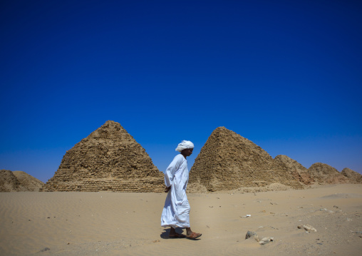 Sudan, Nubia, Nuri, sudanese man in front of the royal pyramids of napata