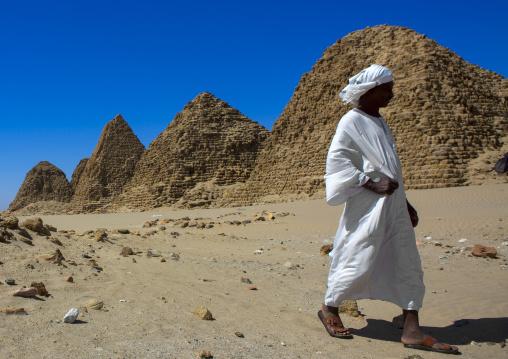 Sudan, Nubia, Nuri, sudanese man in front of the royal pyramids of napata
