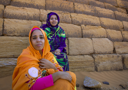 Sudan, Kush, Meroe, sudanese women in front of the pyramids and tombs in royal cemetery