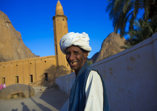 Sudan, Kassala State, Kassala, smiling man in front of khatmiyah mosque at the base of the taka mountains