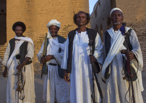 Sudan, Kassala State, Kassala, beja tribe men dancing in front of the khatmiyah mosque at the base of the taka mountains