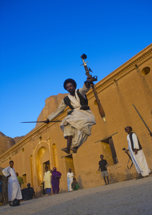Sudan, Kassala State, Kassala, beja tribe men dancing in front of the khatmiyah mosque at the base of the taka mountains