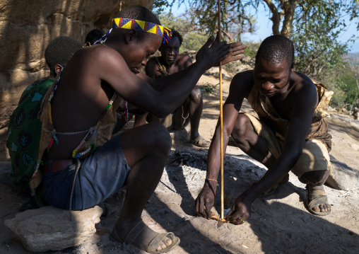Tanzania, Serengeti Plateau, Lake Eyasi, hadzabe tribe making fire with stick woods