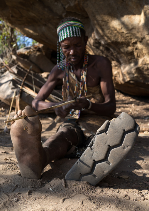 Tanzania, Serengeti Plateau, Lake Eyasi, hadzabe tribe man shoes made from a car tyre