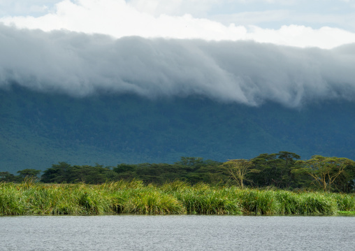 Tanzania, Arusha Region, Ngorongoro Conservation Area, clouds over landscape and mountain range