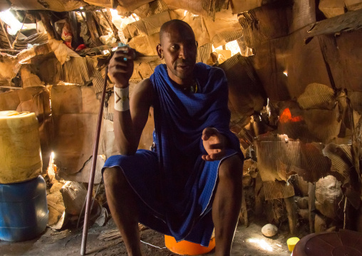 Tanzania, Ashura region, Ngorongoro Conservation Area, maasai man inside his house