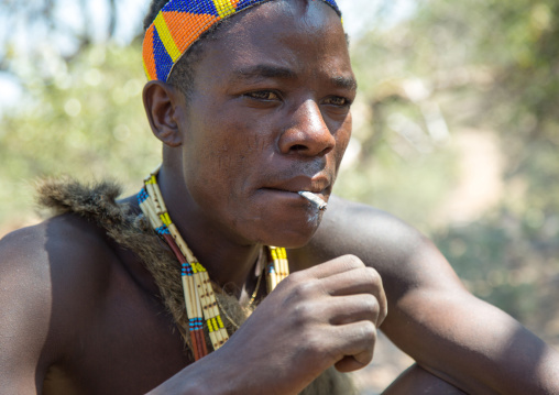 Tanzania, Serengeti Plateau, Lake Eyasi, hadzabe tribe man smoking cannabis