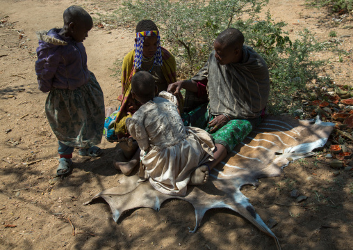 Tanzania, Serengeti Plateau, Lake Eyasi, hadzabe tribe women sit on an animal skin