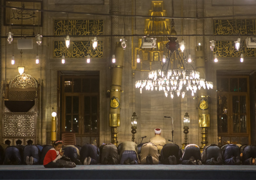 Muslim men praying inside new mosque Yeni Camii, Marmara Region, istanbul, Turkey