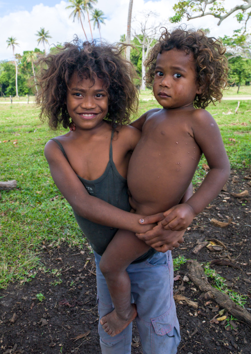 Portrait of a girl carrying her brother who is afraid, Shefa Province, Efate island, Vanuatu
