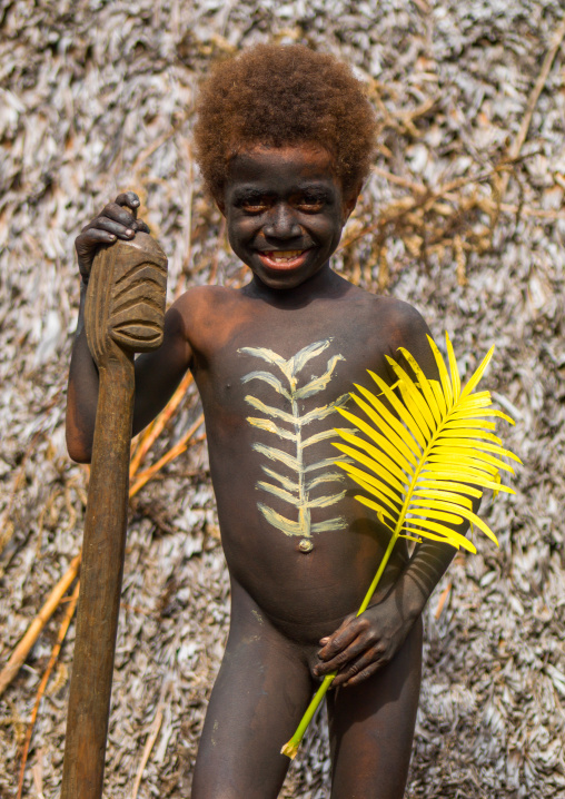 Boy holding a yellow leaf during the palm tree dance of the Small Nambas tribe, Malekula island, Gortiengser, Vanuatu