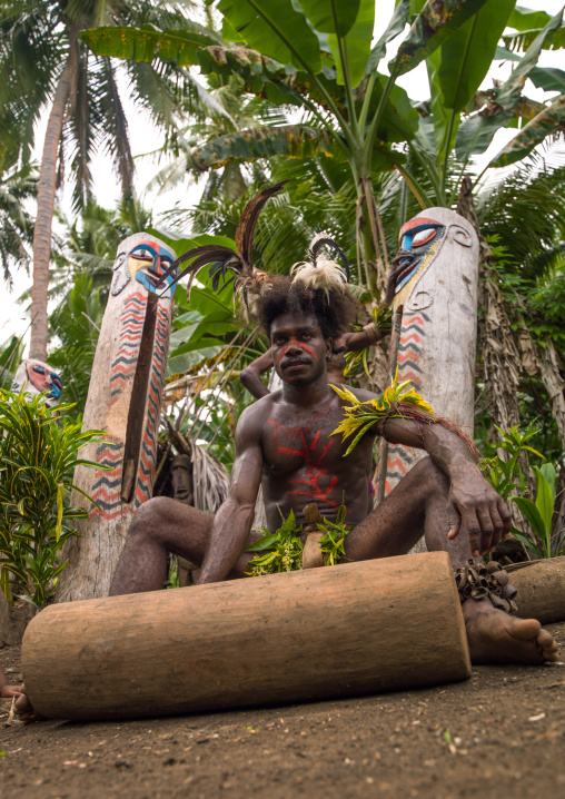 Man beating on a slit drum during the palm tree dance of the Small Nambas tribe, Malekula island, Gortiengser, Vanuatu