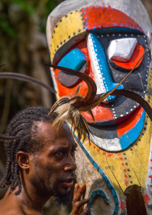 Small Nambas tribesman beating on a slit gong drum during the palm tree dance, Malekula island, Gortiengser, Vanuatu