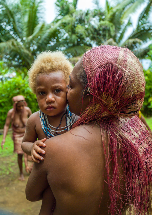 Mother from the Big Nambas tribe kissing her blonde daughter, Malampa Province, Malekula Island, Vanuatu