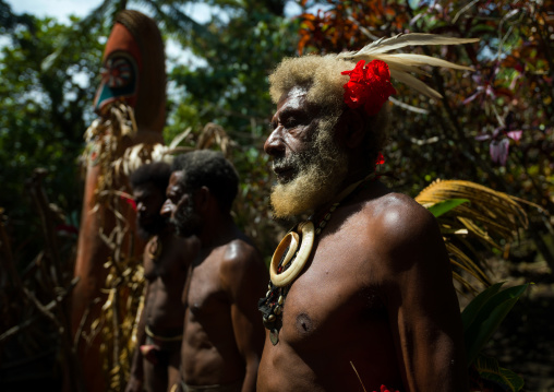 Portrait of chieftain Etul and his sons in front of of a giant slit drum, Ambrym island, Fanla, Vanuatu