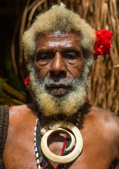 Portrait of chieftain Etul on the Rom dance area in front of a giant slit drum, Ambrym island, Fanla, Vanuatu