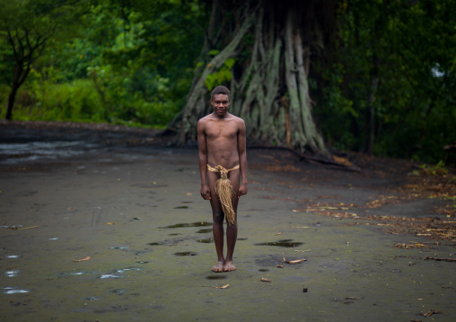 Teenager wearing a penis sheath called a namba standing in the middle of the ceremonial square, Tanna island, Yakel, Vanuatu