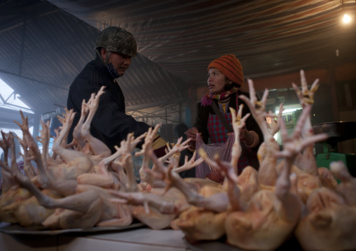 Woman buying chicken at the meat market, Sapa, Vietnam