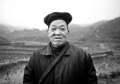 Old black hmong woman in front of paddy fields, Sapa, Vietnam