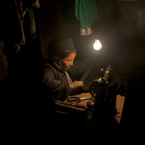 Black hmong girl on a sewing machine, Sapa, Vietnam