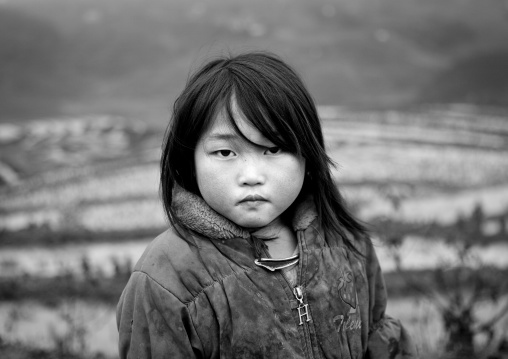 Black hmong young girl in front of terrace paddy fields, Sapa, Vietnam