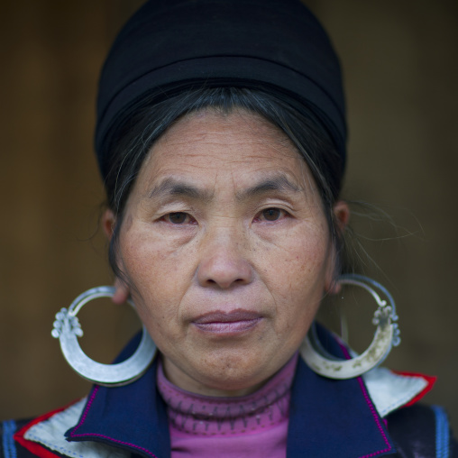 Black hmong woman with traditional headgear and earrings, Sapa, Vietnam