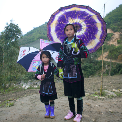 Black hmong girls under traditional umbrellas, Sapa, Vietnam