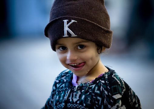Girl With Toothy Smile Wearing A Woollen Hat In Sanaa, Yemen