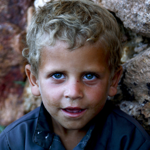 Blue Eyed Boy With Blond Hair Looking Up And Smiling In Shahara, Yemen
