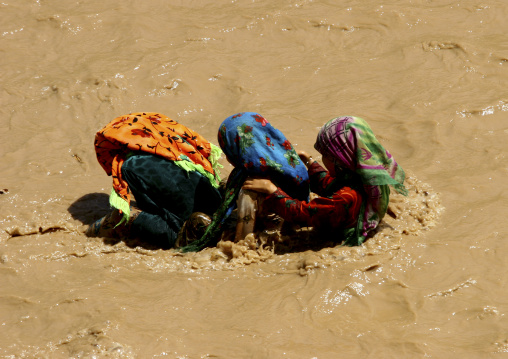 Three Girls Playing In A River Using A Palm Tree As A Flotation Boat, Tihama, Yemen