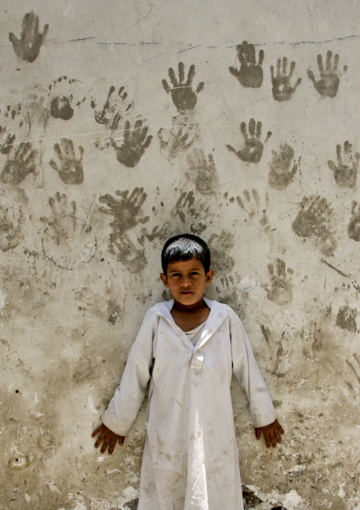 Child In Front Of A Wall Covered With Handprints To Protect From The Evil Eye, Sanaa, Yemen