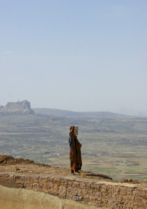 Woman Carrying A Bucket Of Water On Her Head And Looking Over The Plain, Ina, Yemen