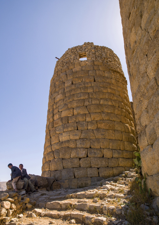 Yemeni boys at the bottom of a stone tower, Sanaa Governorate, Kholan, Yemen