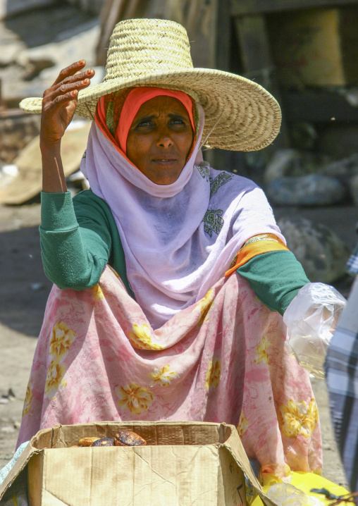 Yemeni woman with a straw hat selling bread, Janad Region, Taiz, Yemen