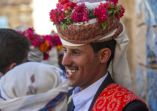 Grooms with turbans decorated with flowers during a wedding, Amran Governorate, Thula, Yemen