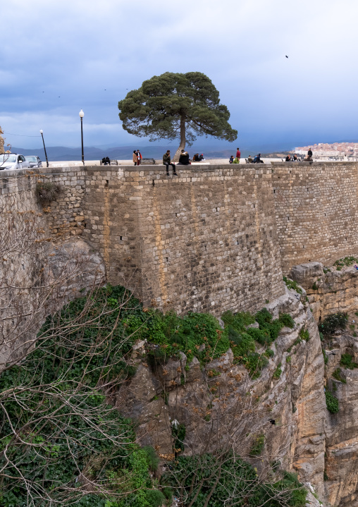 Algerian people sit on the edge of the canyon, North Africa, Constantine, Algeria