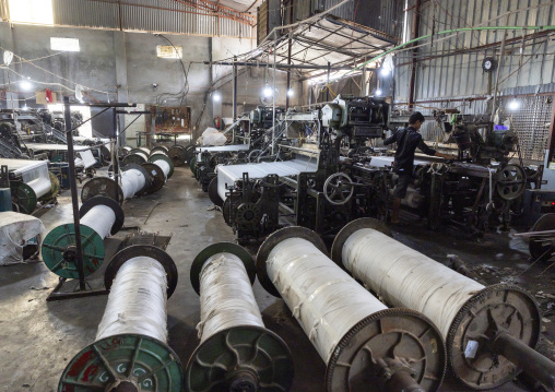 Bangladeshi man working in a textile factory, Dhaka Division, Rupganj, Bangladesh
