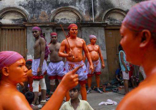 Hindu devotees with swords covered with orange color at Lal Kach festival, Dhaka Division, Munshiganj, Bangladesh